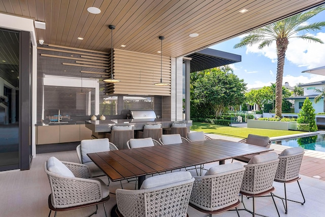 view of patio / terrace with outdoor dining area and an outdoor pool