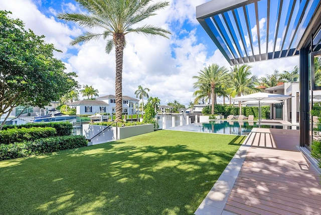 view of yard featuring fence, an outdoor pool, and a pergola