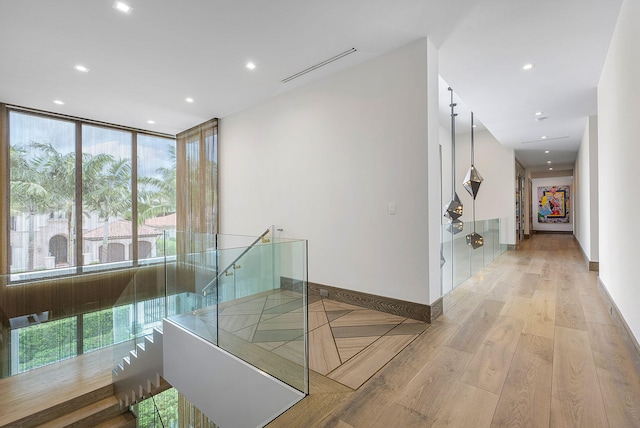 hall featuring light hardwood / wood-style floors and floor to ceiling windows