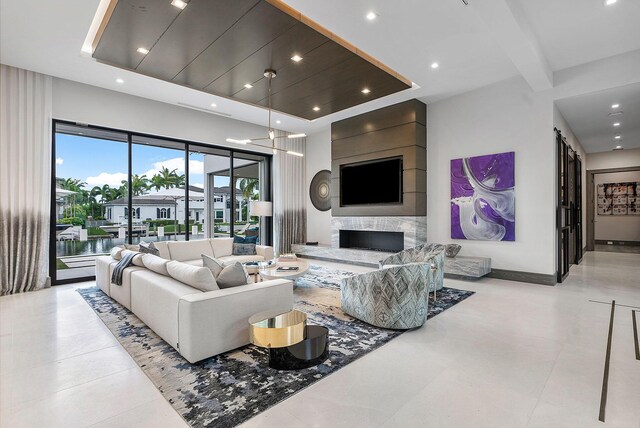 living room with light tile patterned floors, a fireplace, and a towering ceiling