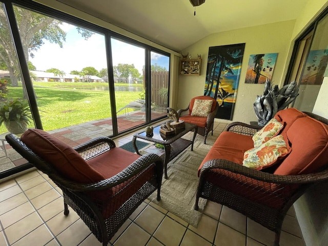 sunroom with ceiling fan and vaulted ceiling