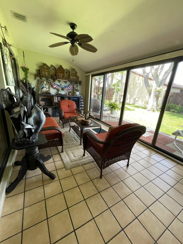 sunroom / solarium with ceiling fan and lofted ceiling