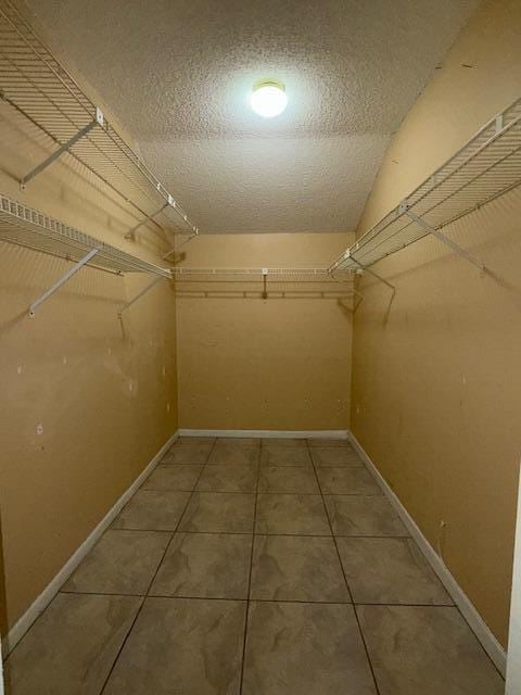 spacious closet featuring tile patterned floors