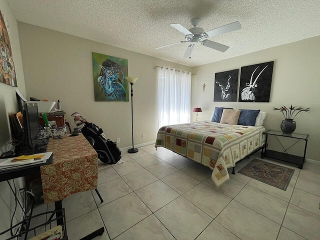 tiled bedroom with a textured ceiling and ceiling fan