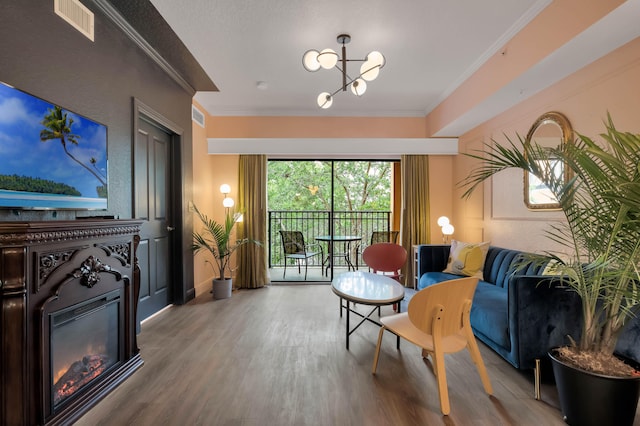 interior space featuring hardwood / wood-style flooring, ornamental molding, and an inviting chandelier