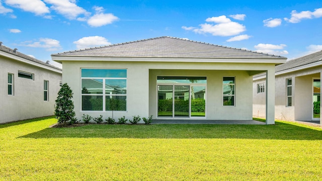 rear view of property with a lawn