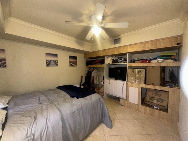 tiled bedroom with ornamental molding and ceiling fan