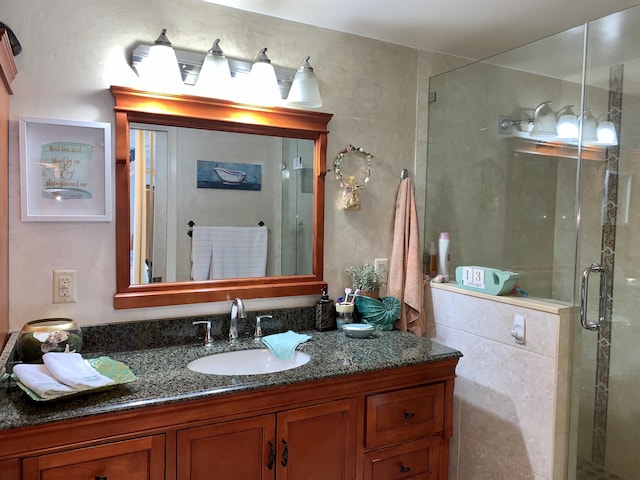 bathroom with vanity and a shower stall