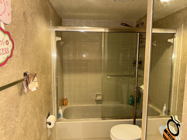 bathroom with shower / bath combination with glass door and toilet