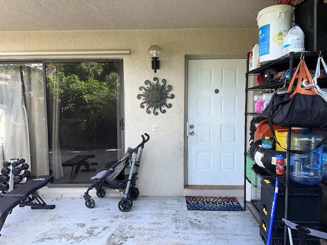 entrance to property featuring stucco siding