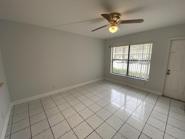 unfurnished room with ceiling fan and light tile patterned floors