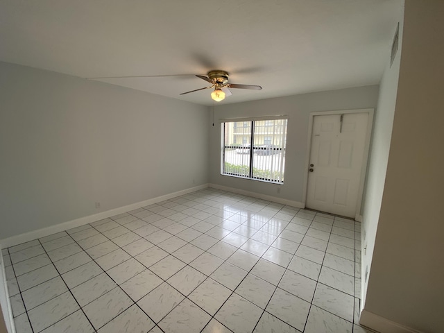 unfurnished room featuring light tile patterned floors and ceiling fan