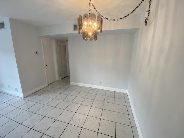 spare room featuring a notable chandelier