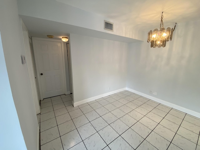 empty room featuring a notable chandelier