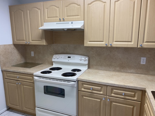 kitchen featuring electric stove, light tile patterned floors, and tasteful backsplash