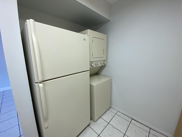 washroom featuring light tile patterned floors and stacked washer and clothes dryer