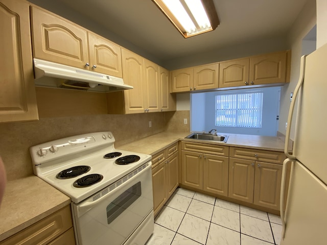 kitchen featuring light brown cabinets, white appliances, and backsplash