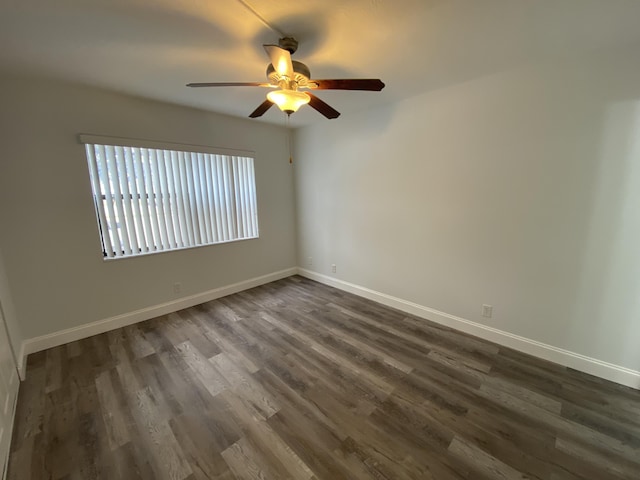 unfurnished room featuring ceiling fan and dark hardwood / wood-style flooring