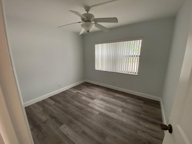 spare room featuring ceiling fan and dark hardwood / wood-style floors