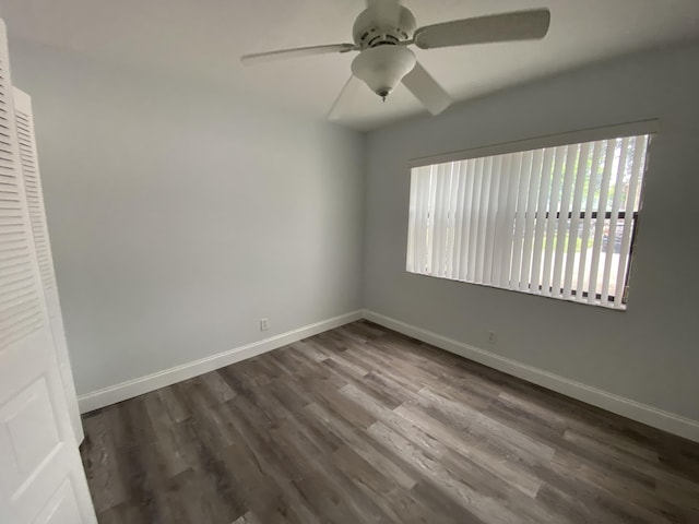 spare room with ceiling fan and dark wood-type flooring