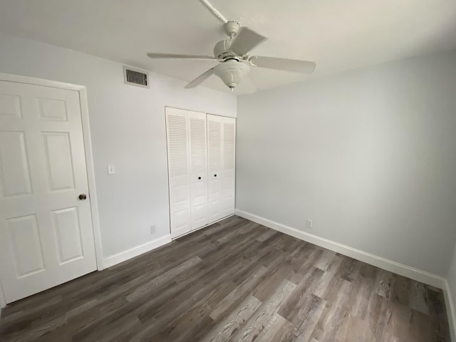 unfurnished bedroom featuring a closet, ceiling fan, and dark hardwood / wood-style floors