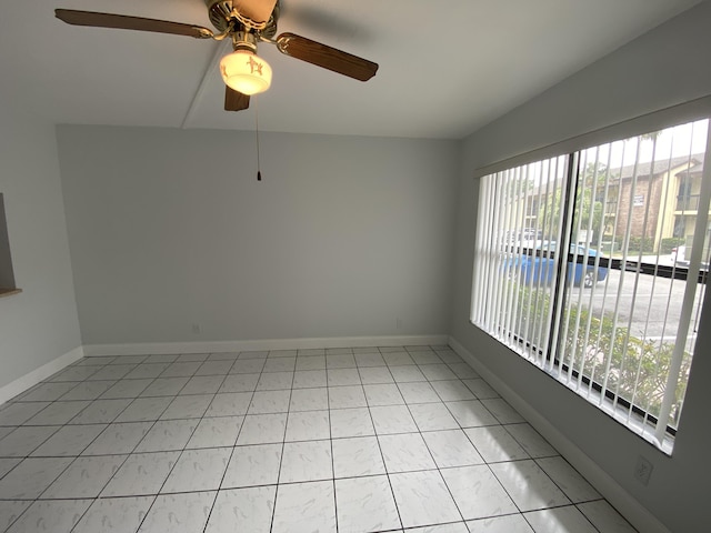 spare room featuring ceiling fan and light tile patterned flooring