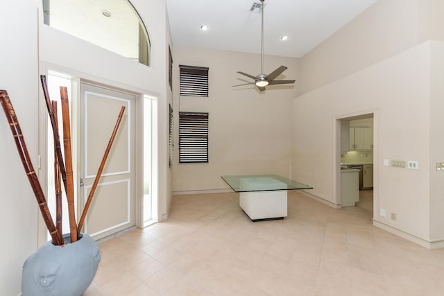 foyer featuring a high ceiling and ceiling fan