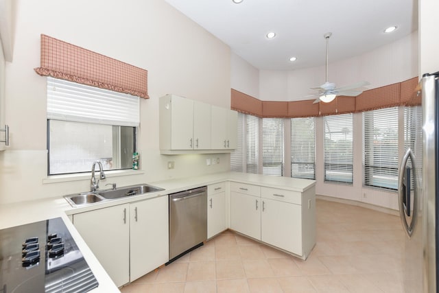 kitchen with white cabinetry, sink, ceiling fan, stainless steel appliances, and kitchen peninsula