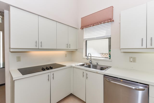 kitchen featuring white cabinetry, sink, stainless steel dishwasher, and black electric stovetop