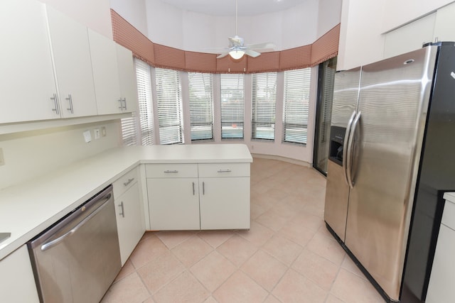 kitchen with white cabinetry, ceiling fan, stainless steel appliances, kitchen peninsula, and light tile patterned floors