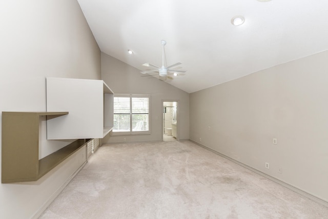 unfurnished living room with light carpet, vaulted ceiling, and ceiling fan