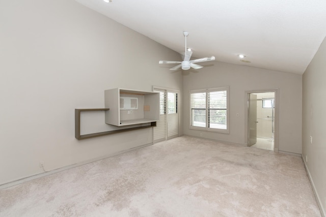 unfurnished living room with ceiling fan, light colored carpet, a healthy amount of sunlight, and lofted ceiling