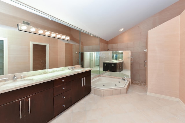 bathroom featuring tile patterned floors, plus walk in shower, vanity, and lofted ceiling