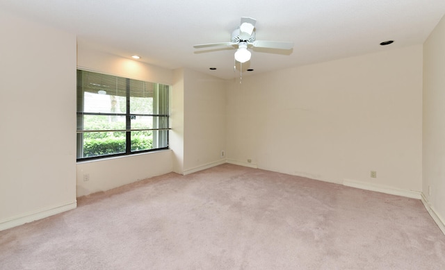 carpeted empty room featuring ceiling fan