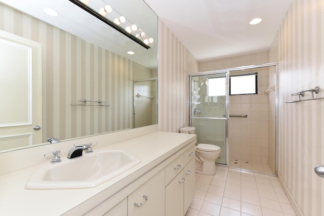 bathroom with tile patterned flooring, vanity, toilet, and an enclosed shower