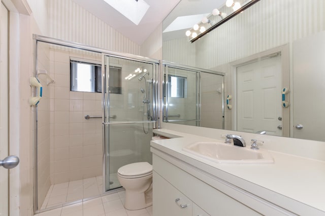 bathroom featuring tile patterned floors, vanity, toilet, and walk in shower