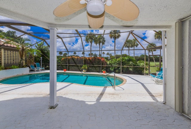 view of pool with a lanai, ceiling fan, and a patio area