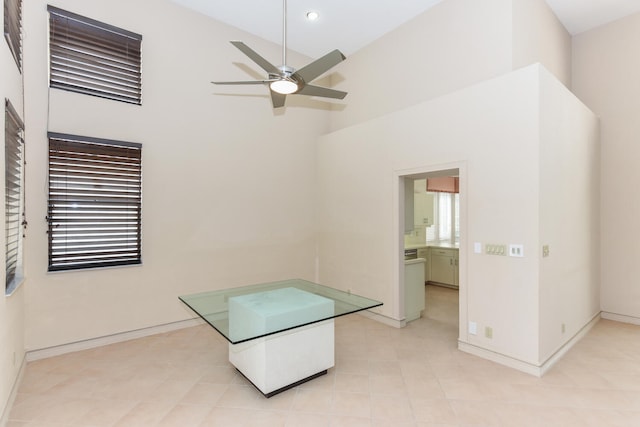 interior space featuring a high ceiling and ceiling fan