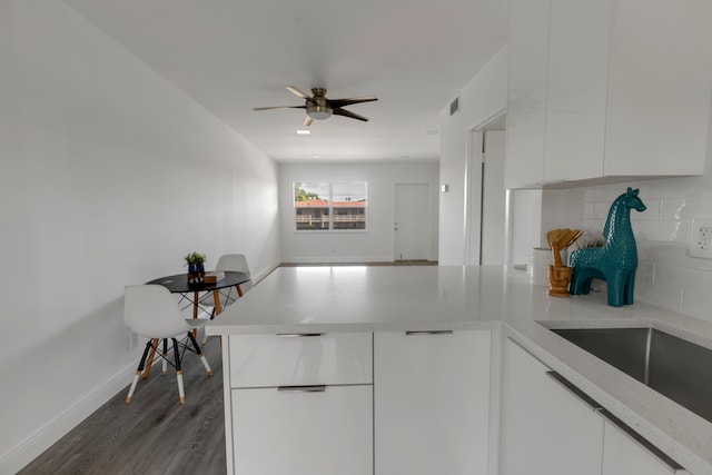 kitchen featuring tasteful backsplash, white cabinetry, dark hardwood / wood-style floors, and ceiling fan