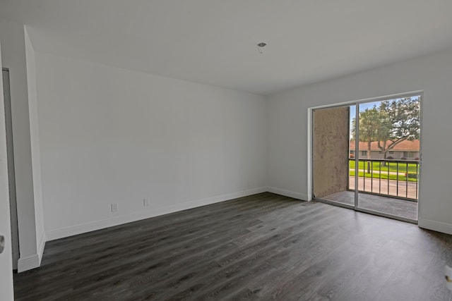 empty room with dark hardwood / wood-style flooring