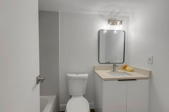 bathroom featuring vanity, a bath, and toilet