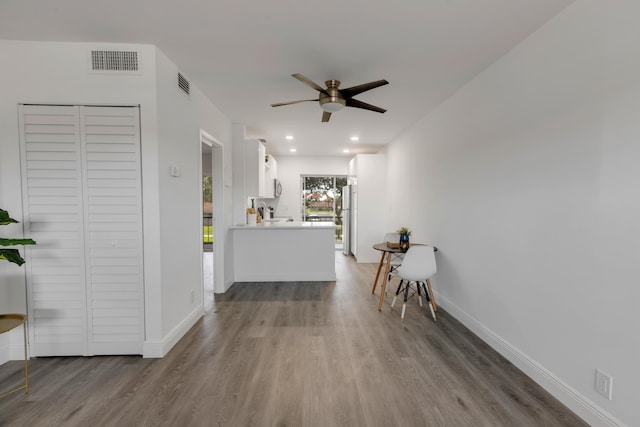 hall with hardwood / wood-style flooring