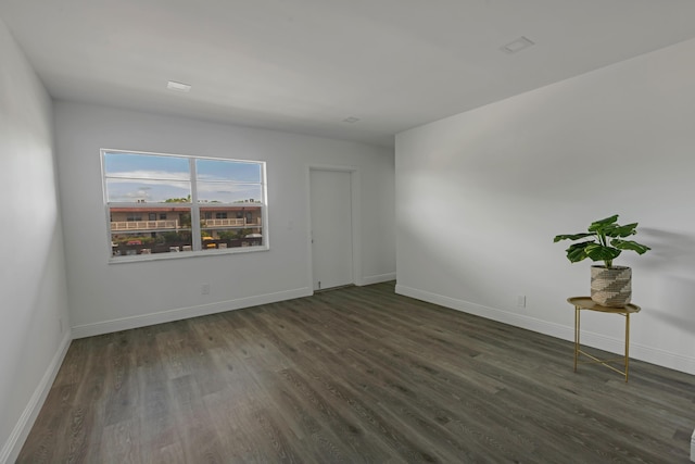 spare room featuring dark wood-type flooring