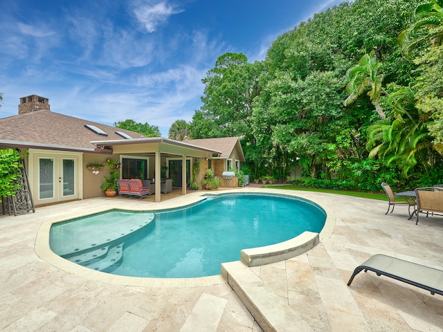 view of pool featuring french doors and a patio area