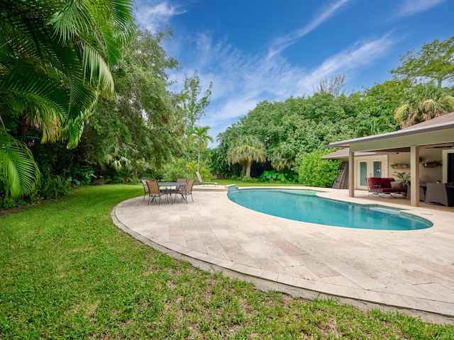 view of pool with a yard and a patio area