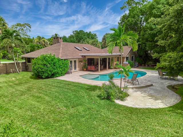 view of pool featuring a patio area and a lawn