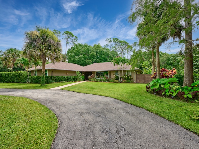 single story home featuring a front yard