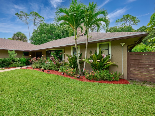 ranch-style home featuring a front yard