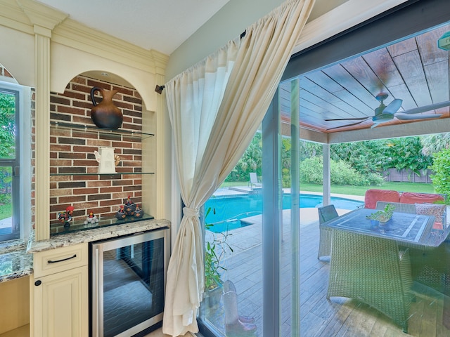 doorway with light hardwood / wood-style floors and wine cooler