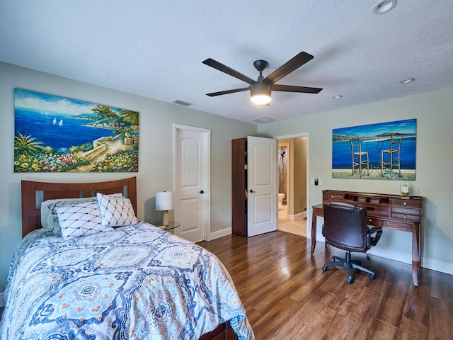 bedroom featuring dark wood-type flooring, a textured ceiling, and ceiling fan